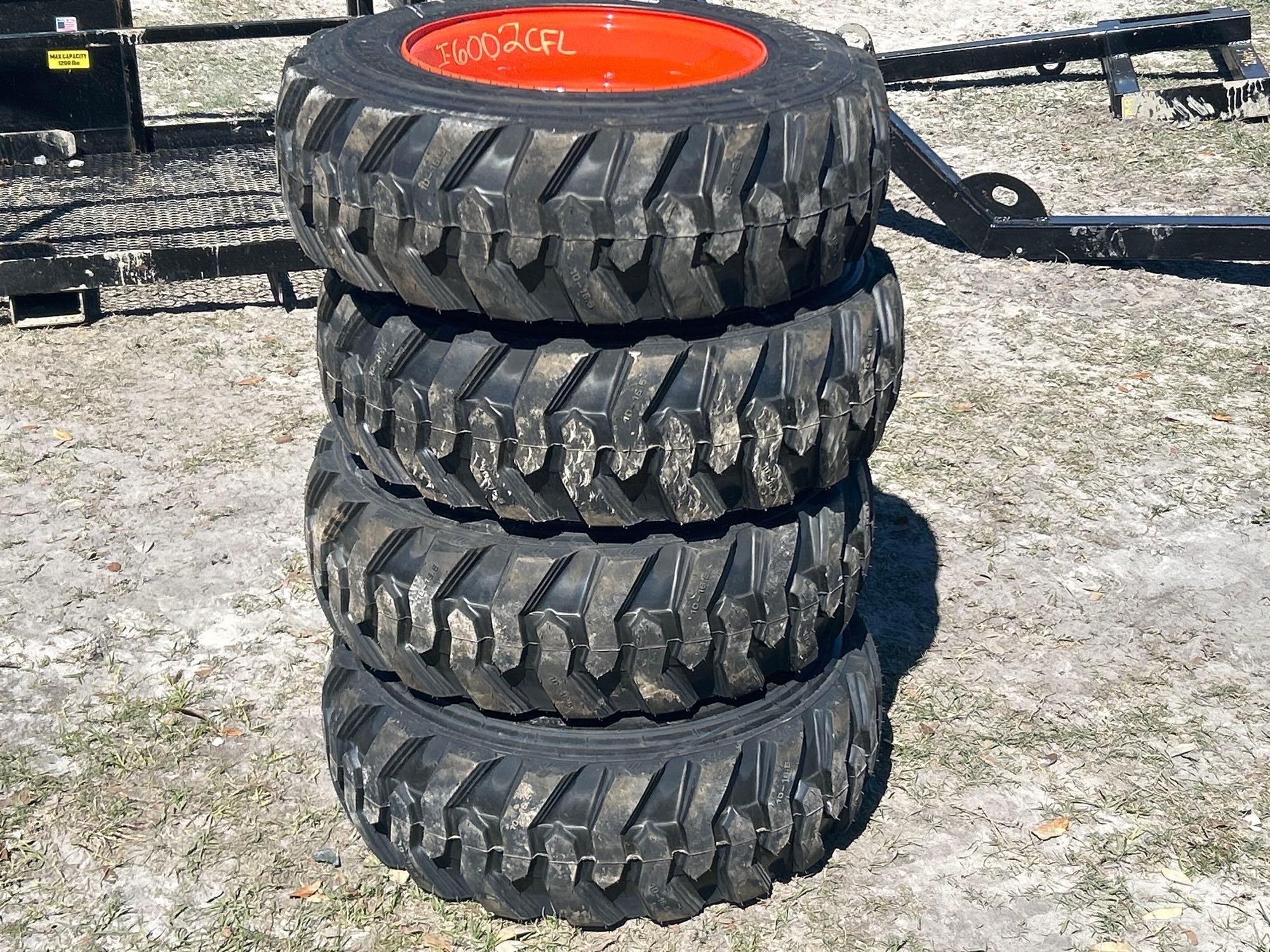 Lot of 4 10-16.5NHS Skid Steer Wheels and Tires (A61572)