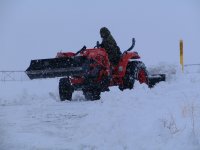 Pushing Snow off Highway Front of Blews.JPG